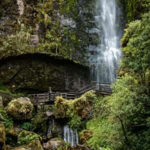 eSIM Ecuador brown wooden bridge near waterfalls during daytime