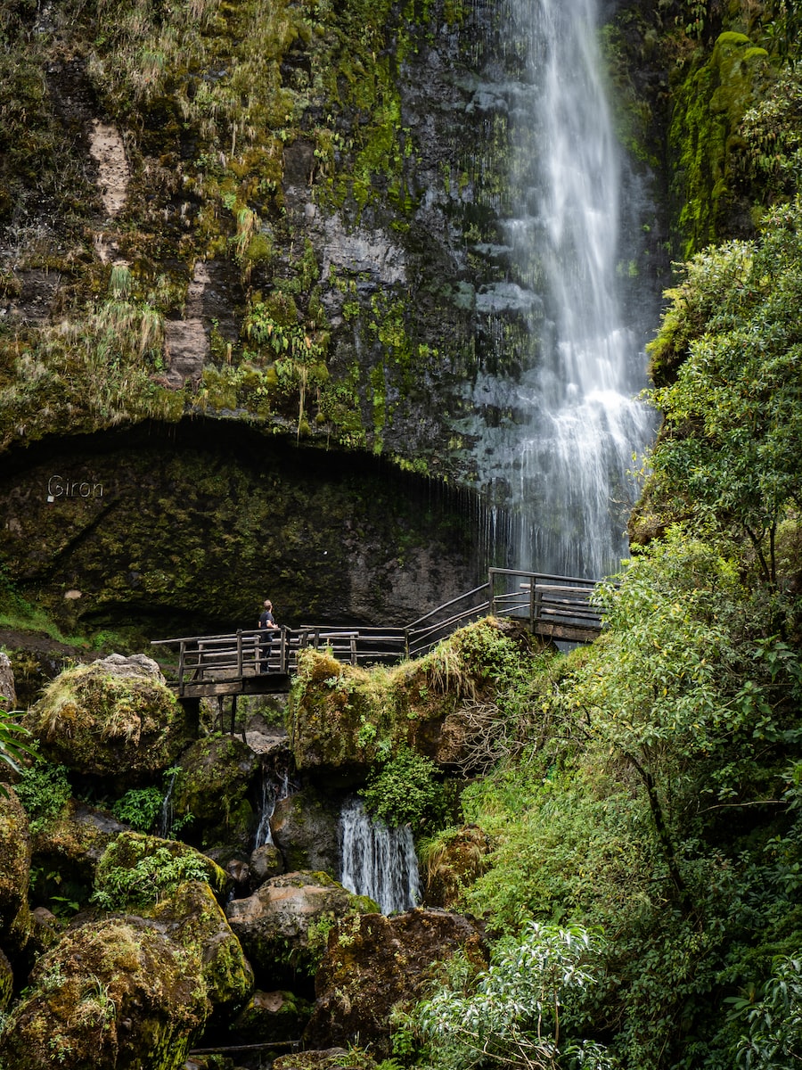 eSIM Ecuador brown wooden bridge near waterfalls during daytime
