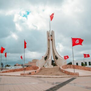 flags on brown concrete bridge during daytime