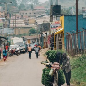man walking beside his bicycle
