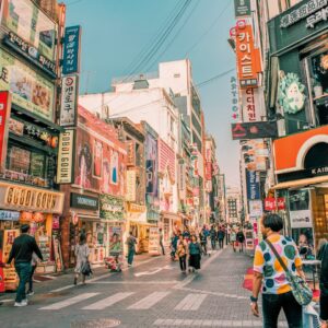 people walking on road surrounded by buildings