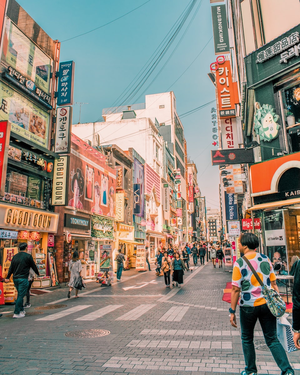 people walking on road surrounded by buildings