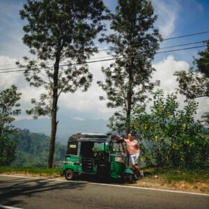 man in green jacket riding green and black auto rickshaw on road during daytime